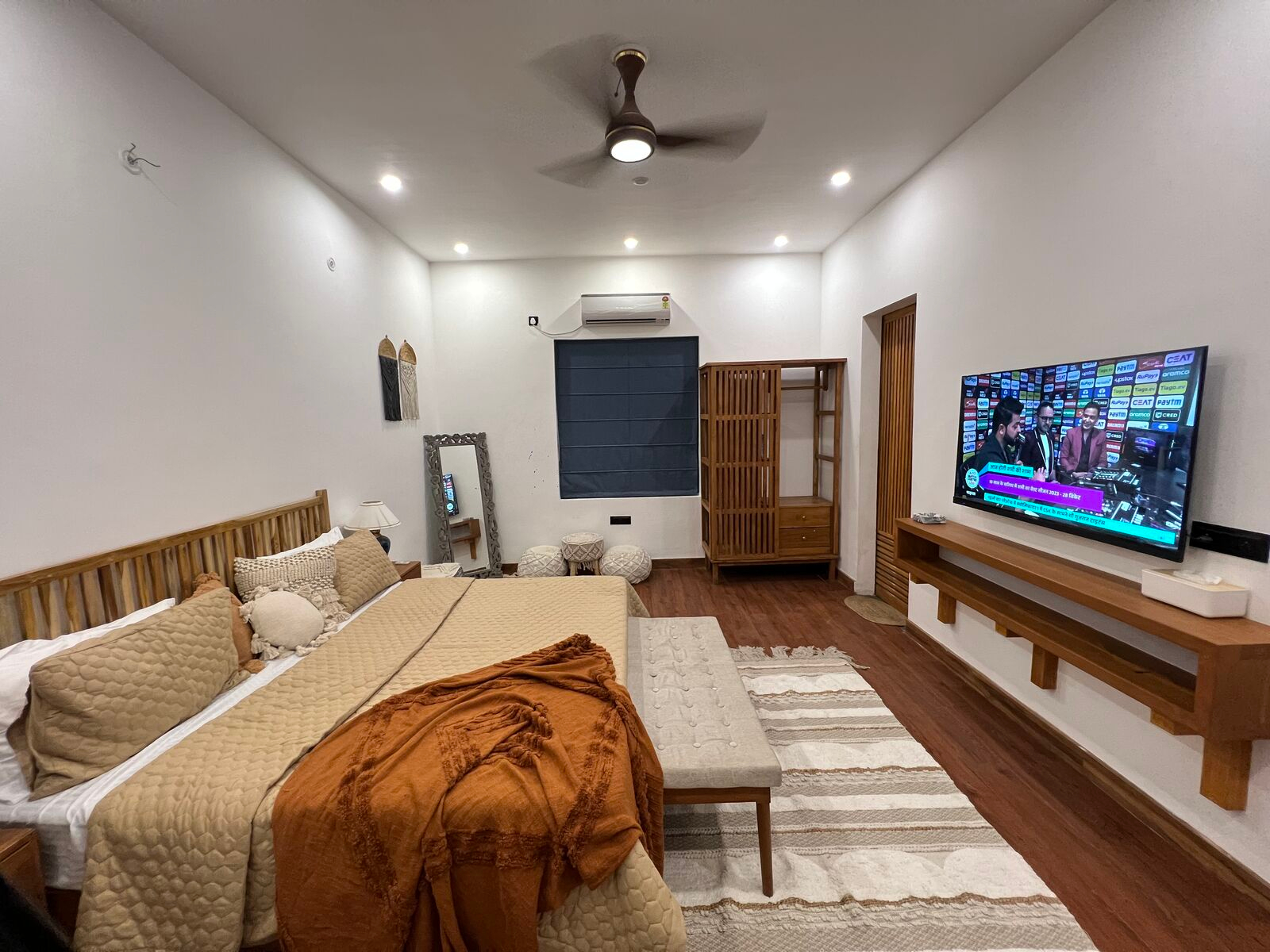 Air-conditioned bedroom with king bed, warm linens and smart TV